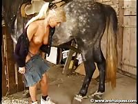 Mature blonde came in the stable for horse