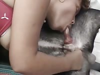 Zoophilia girl enjoys sucking on a dog cock