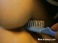 Comb gets inserted to a sexy teen's ass
